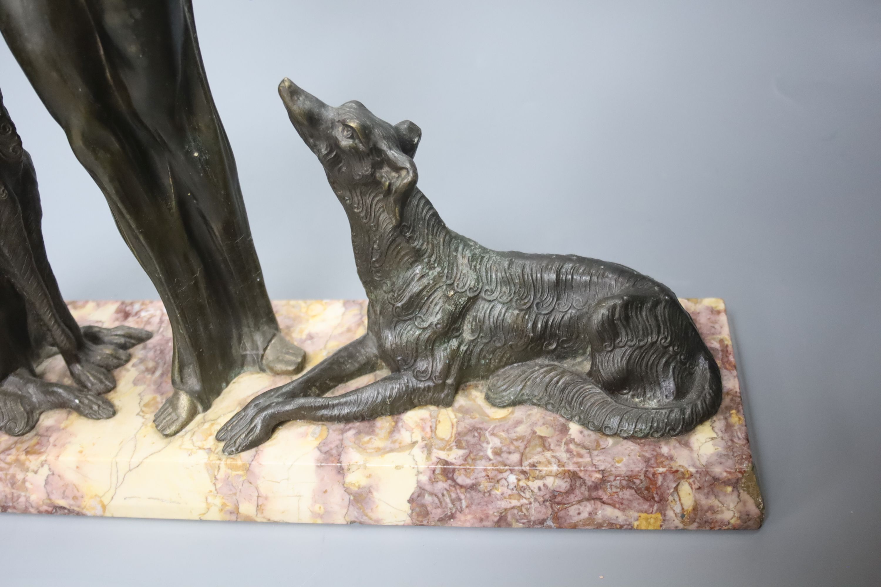 A Spelter Art Deco figure of a dog and borzoi, on a marble base, height 45cm